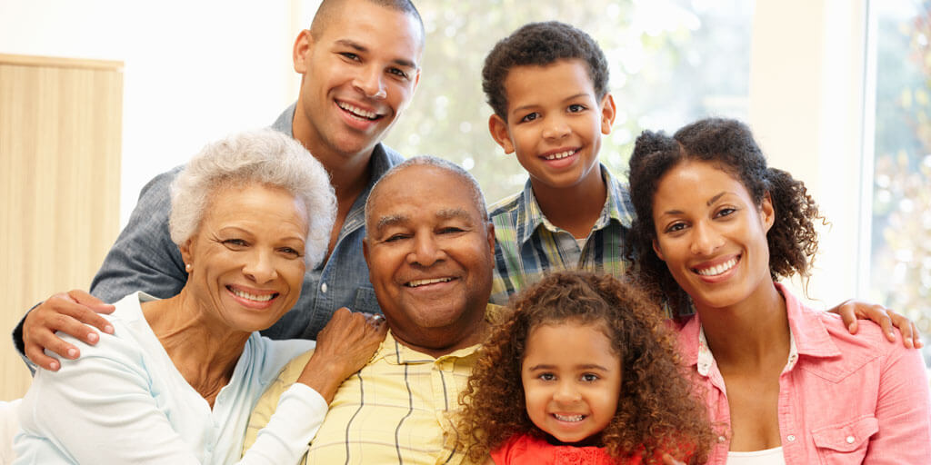 A multigenerational family is smiling for the camera.