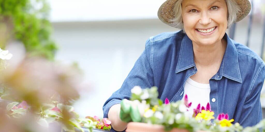 My flowers are looking quite splendid Portrait of a delighted senior woman gardening
