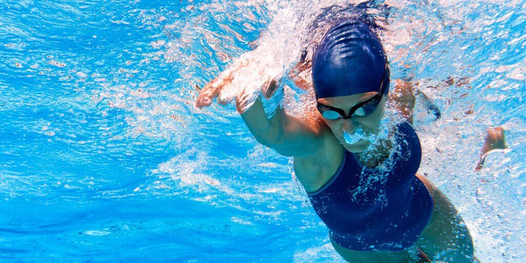 Woman swimming laps in a pool